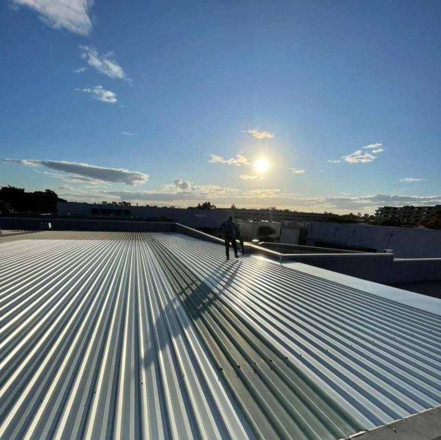A man is standing on the roof of a building.