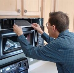 Technician_Repairing_Microwave_Oven