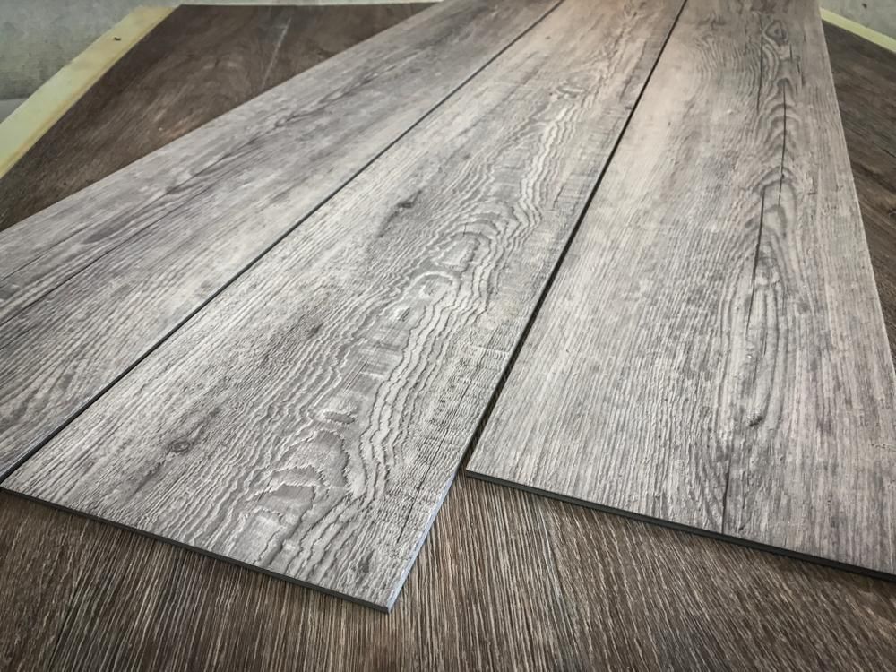Two Pieces Of Wood Are Laying On Top Of Each Other On A Table — B2B Flooring Solutions In Clarence Valley, NSW
