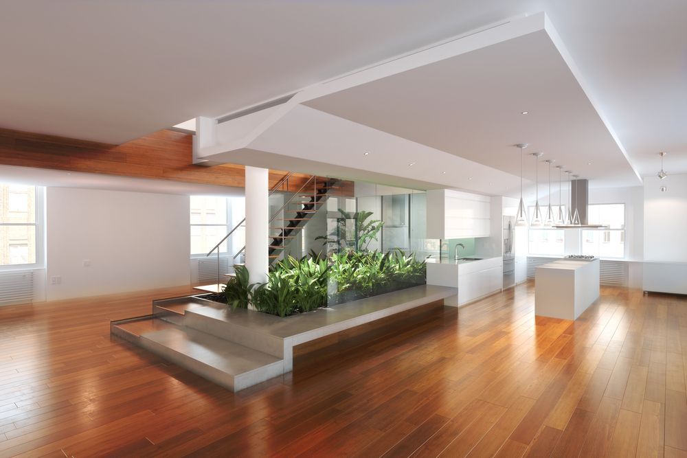 A Large Empty Room With Hardwood Floors And A Staircase — B2B Flooring Solutions In Coffs Harbour, NSW