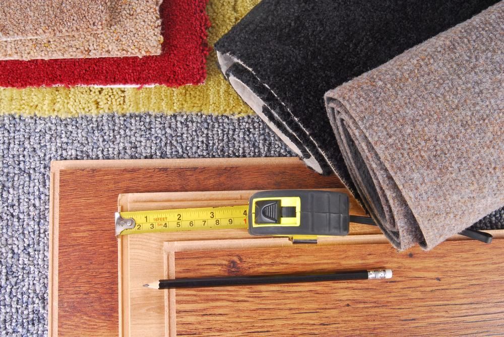 A Tape Measure Is Sitting On Top Of A Wooden Table Next To A Pencil — B2B Flooring Solutions In Clarence Valley, NSW