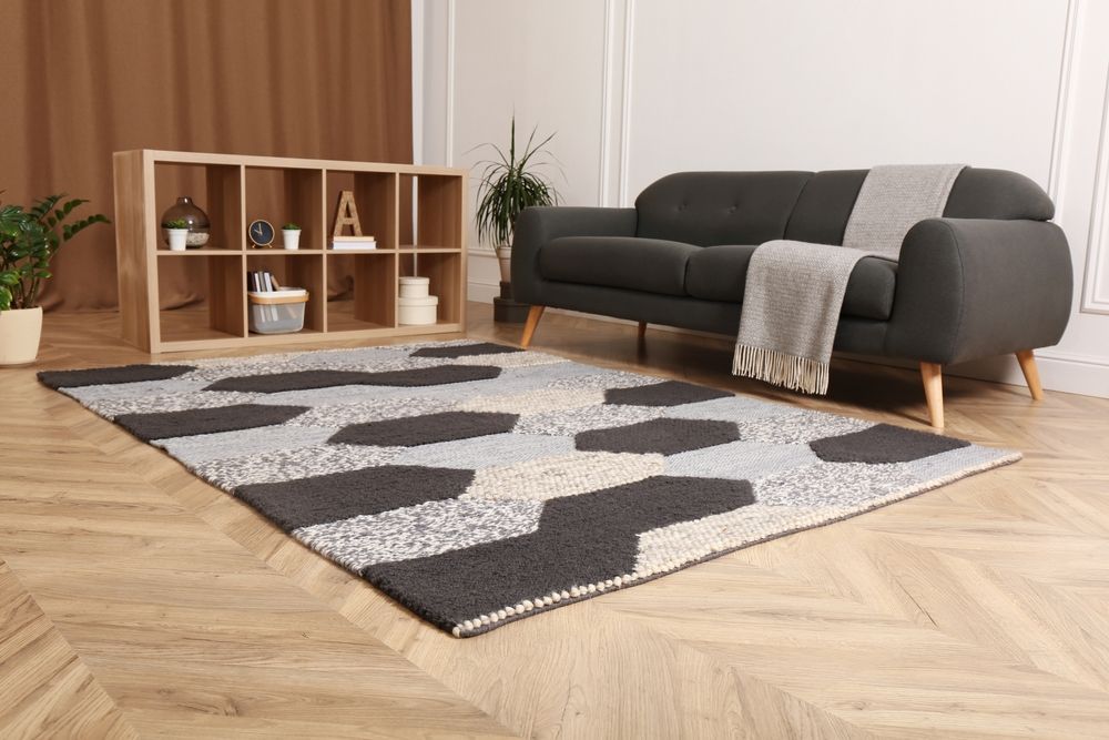 A Living Room With A Couch And A Rug On The Floor — B2B Flooring Solutions In Kempsey, NSW