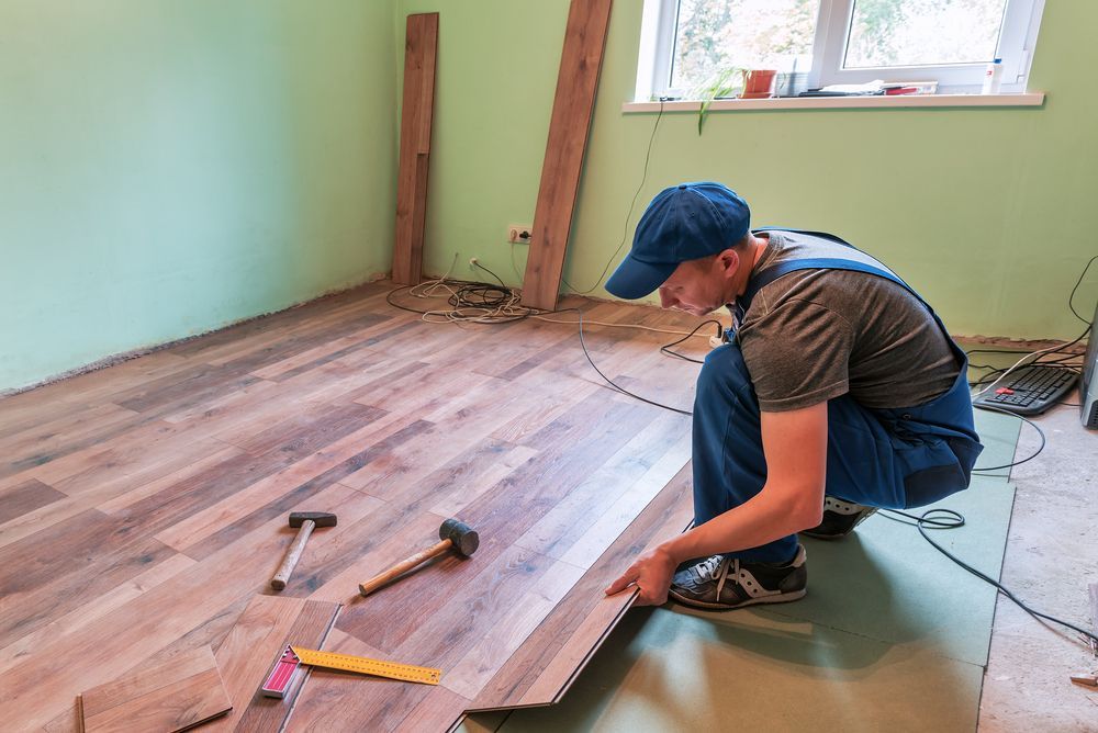 Worker Install The Laminate Floor And Repair — B2B Flooring Solutions In Coffs Harbour, NSW