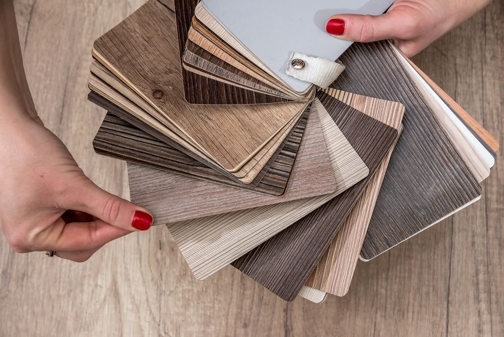 Women Showing Samples Of Laminate And Vinyl Floor Tile
 — B2B Flooring Solutions In Grafton, NSW