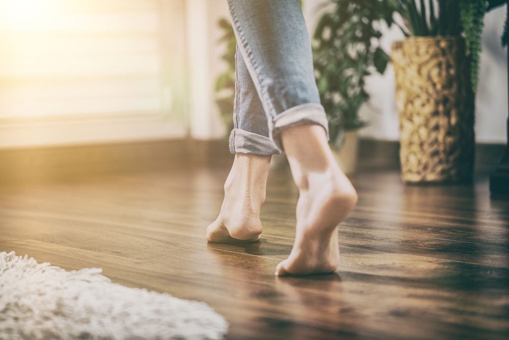 Young Woman Walking In The House On The Warm Floor — B2B Flooring Solutions In Coffs Harbour, NSW