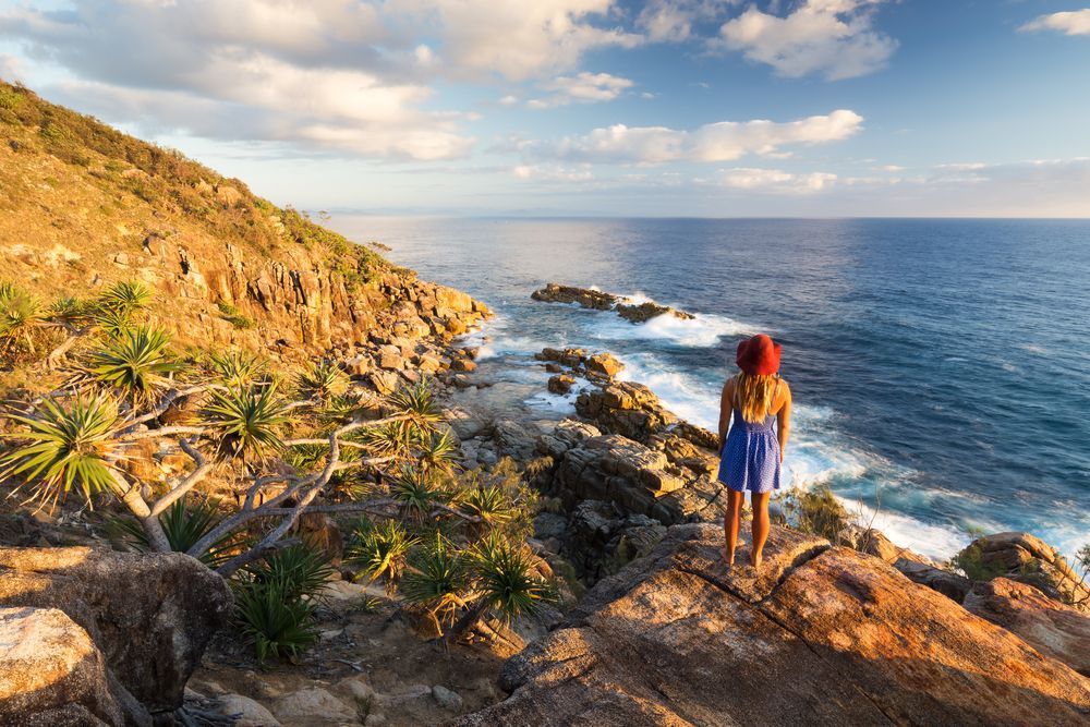A Young Woman Admires A Coastal View At Sunrise Near Coffs Harbour, Australia — B2B Flooring Solutions In Coffs Harbour, NSW