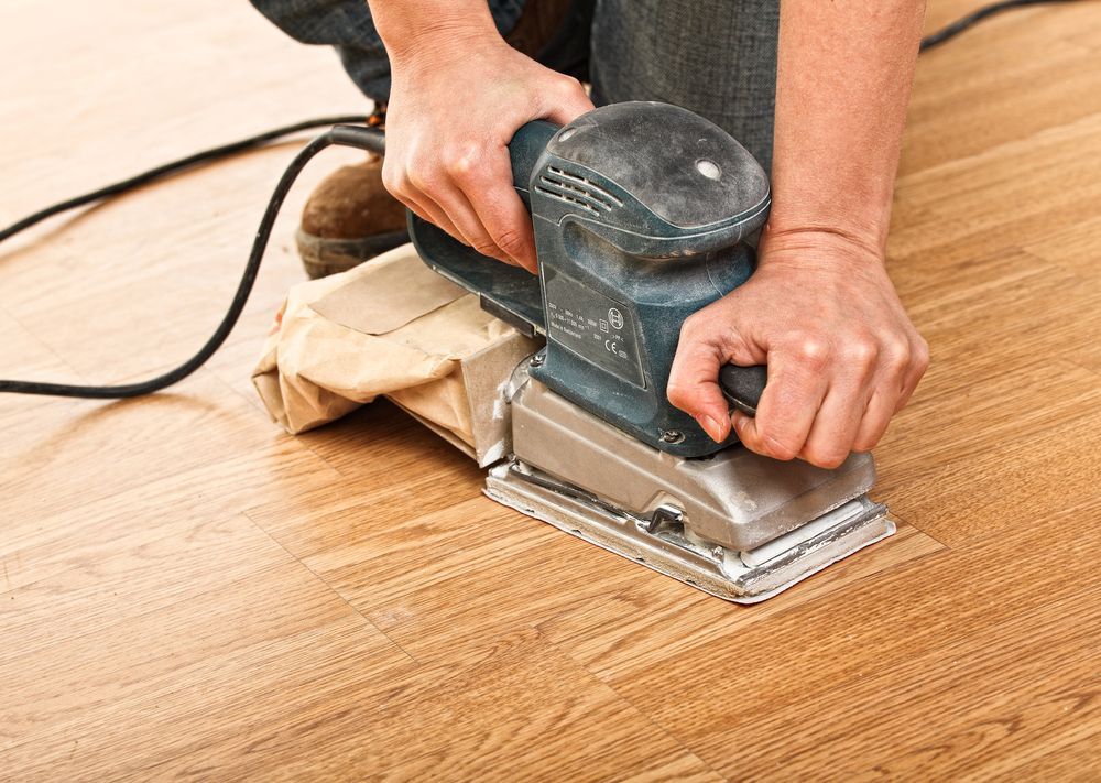 Detail Of Carpenter Use Sander On Wood Floor — B2B Flooring Solutions In Grafton, NSW