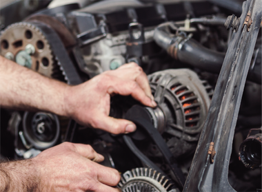 A man is holding a clutch disc in his hands.