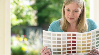 Woman  looking at color chart — Garage Door Services in Green River, WY
