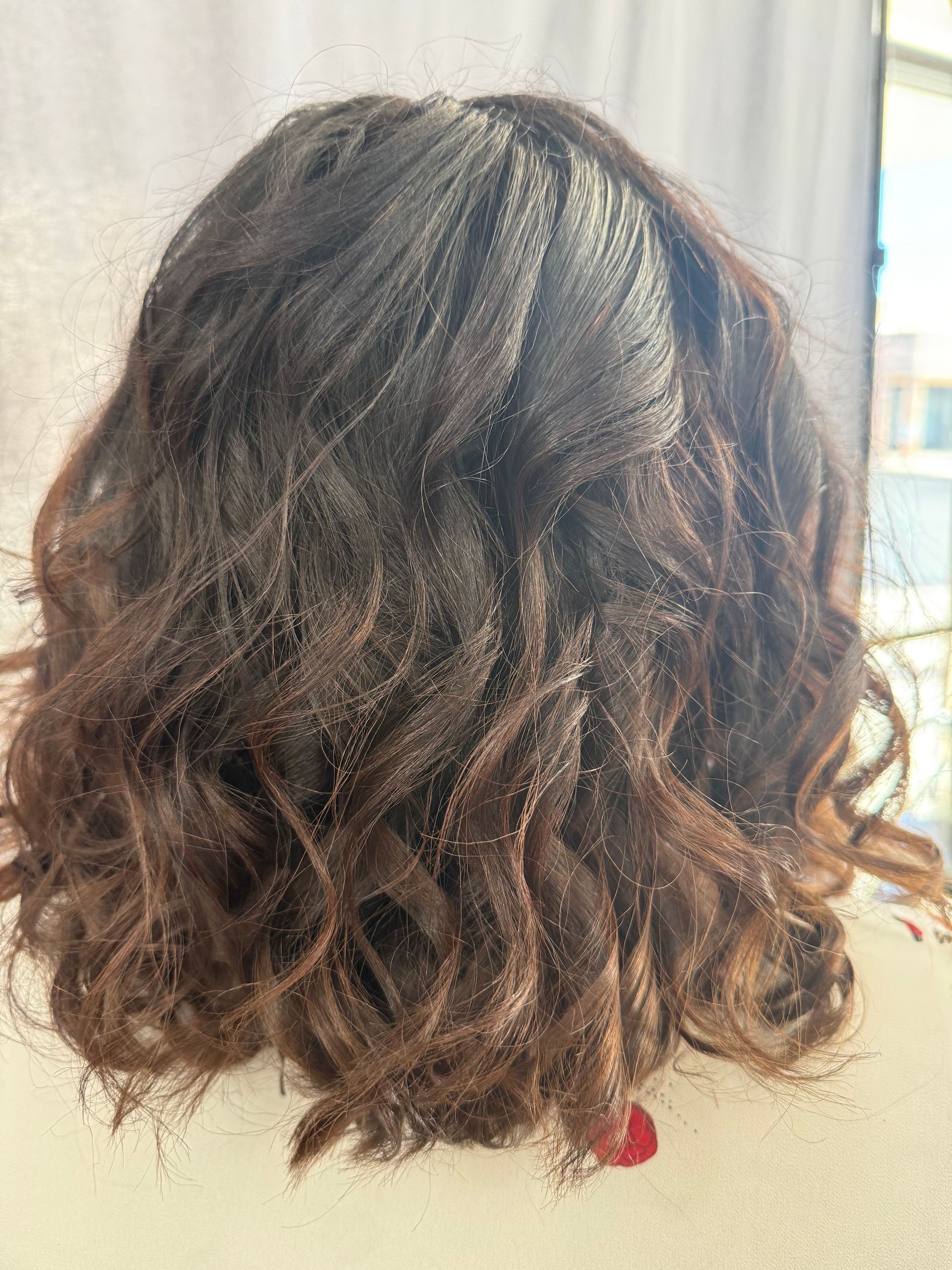 Back view of wavy, dark brown hair.