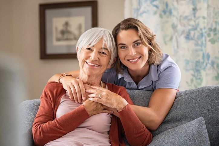 Happy adult daughter embracing senior mother