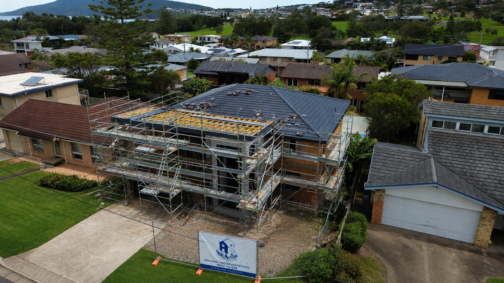 Modern Single-story Brick House With a Tiled Roof, Garage, and Small Front Yard — Wade Adams Constructions in Wingham, NSW