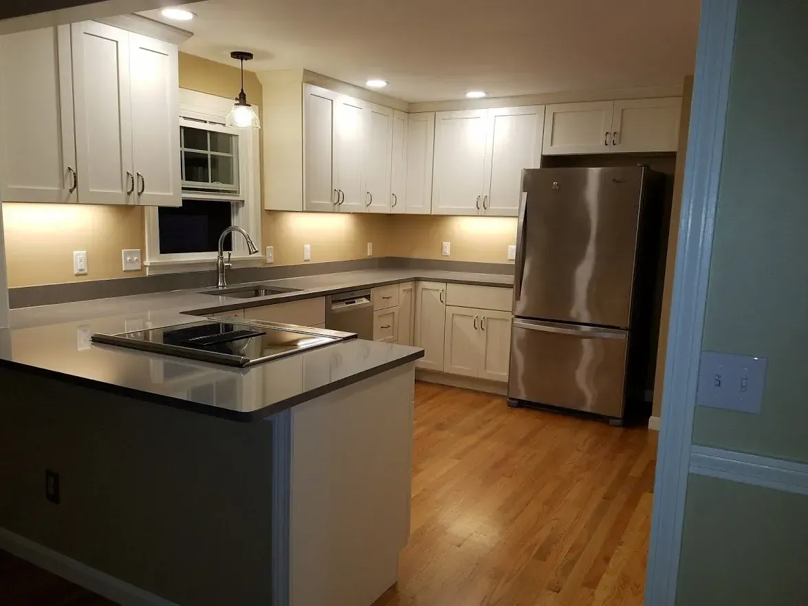 a kitchen with stainless steel appliances and white cabinets