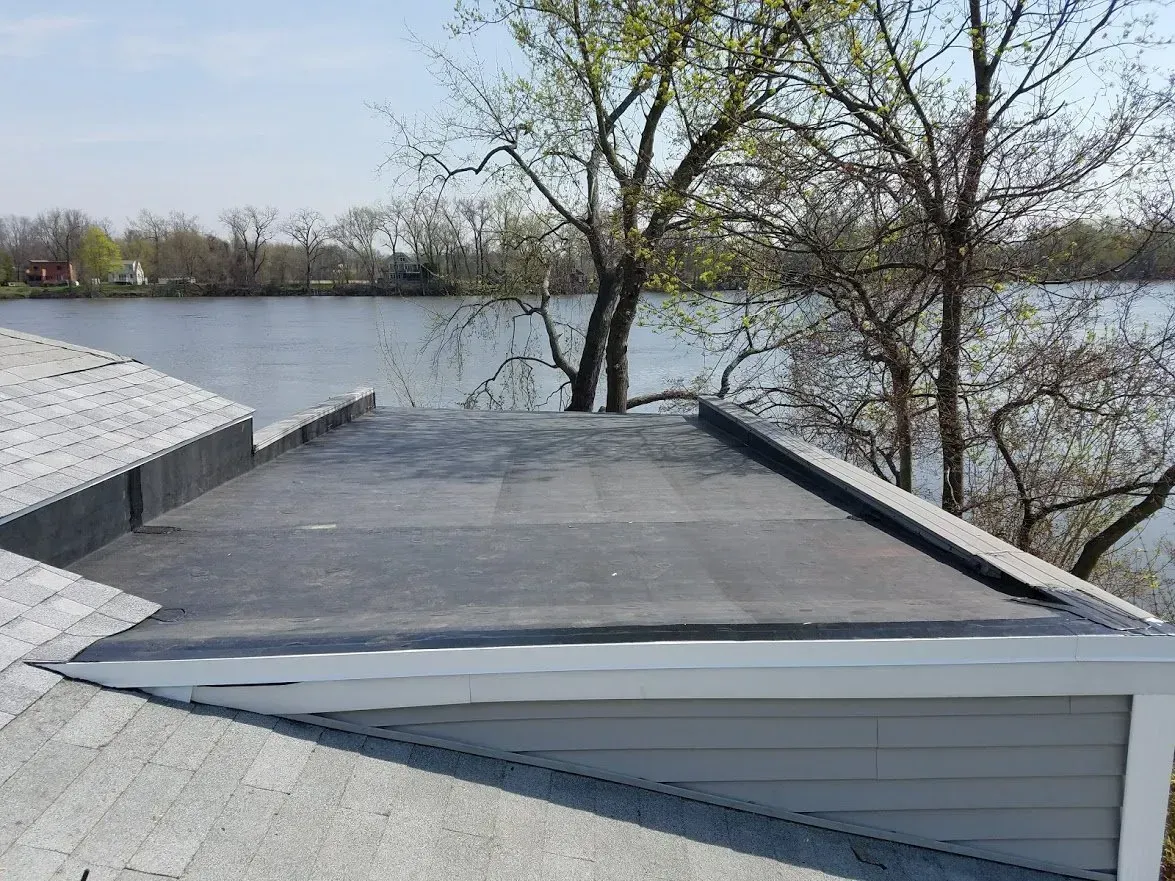 a roof with a view of a lake and trees