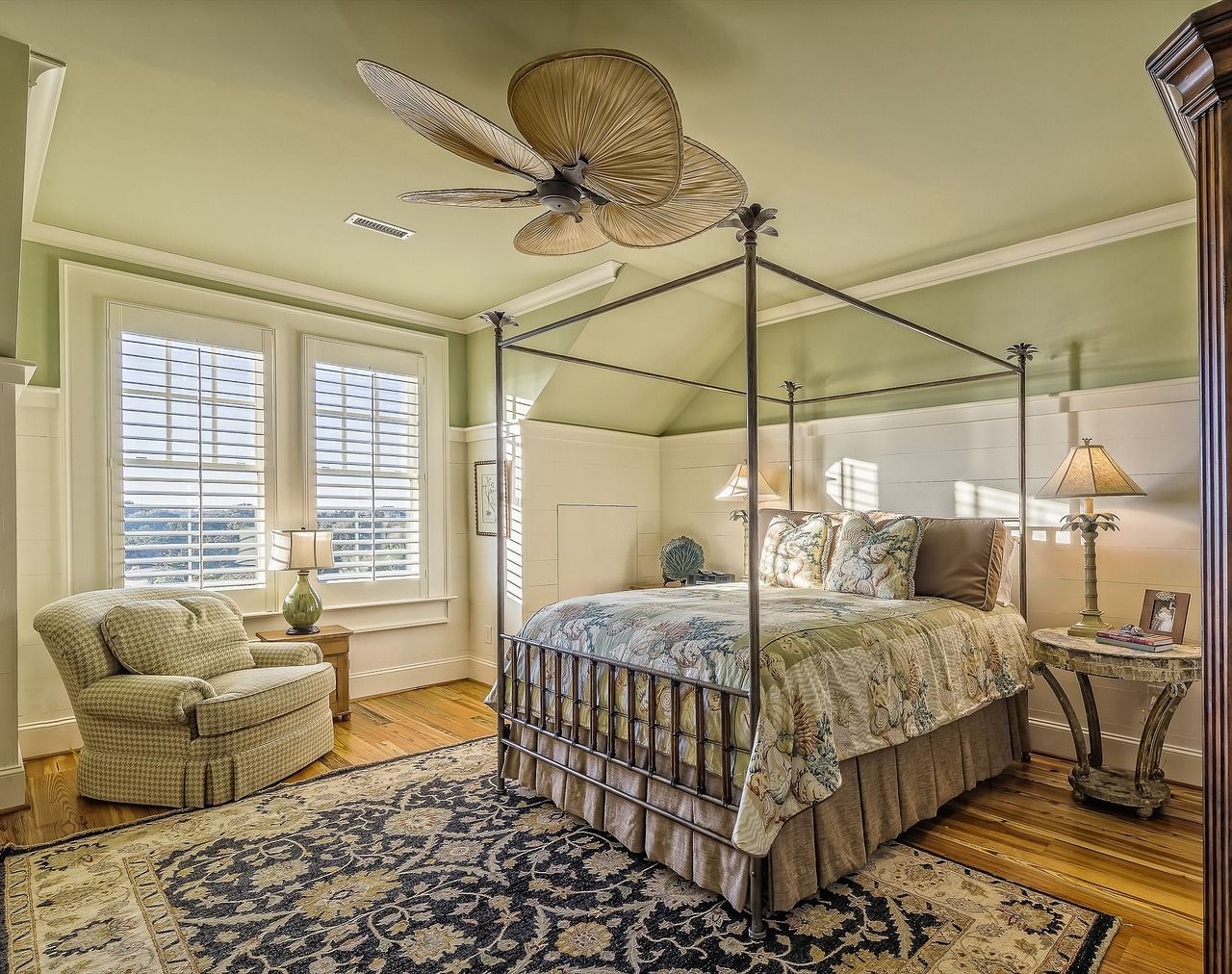 a bedroom with a canopy bed and a ceiling fan 