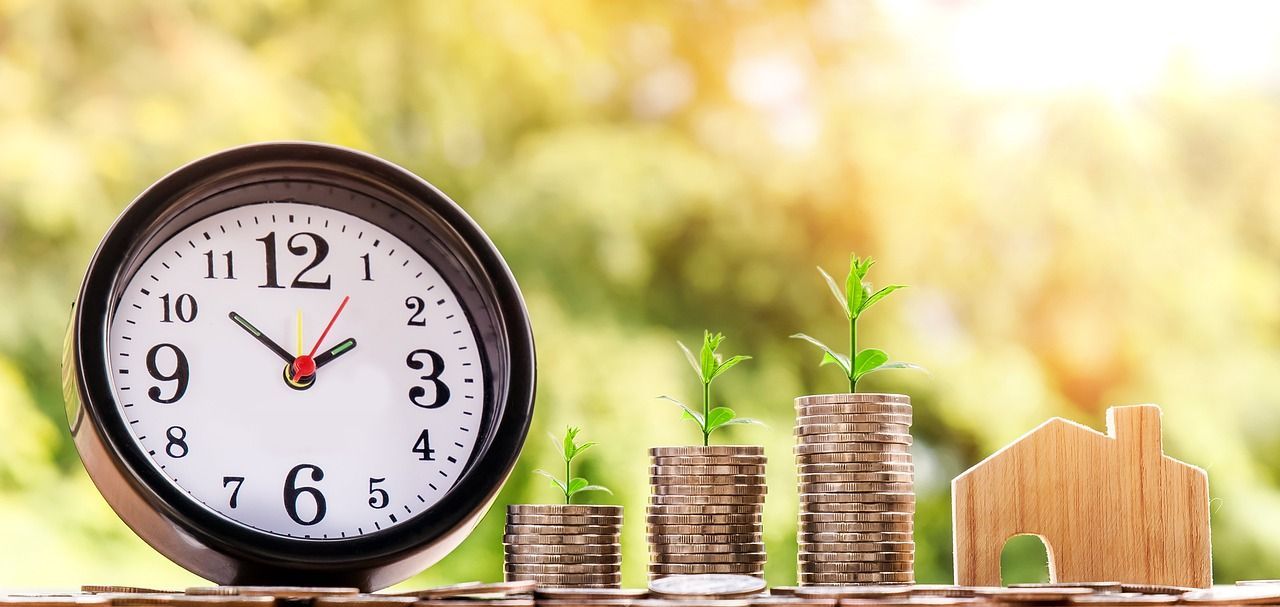 a clock is sitting on top of a pile of coins