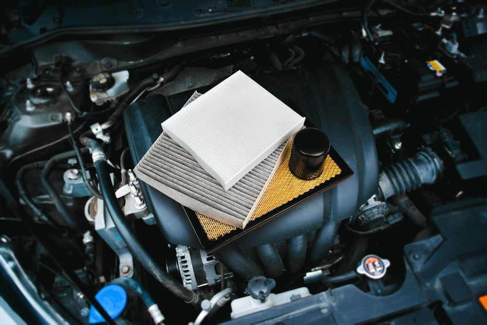 Car engine bay with air and oil filters.