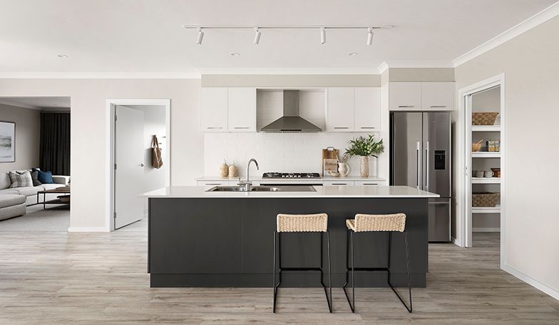 An artist's impression of a kitchen with a large island and stools.