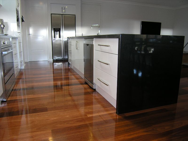 A kitchen with hardwood floors and stainless steel appliances