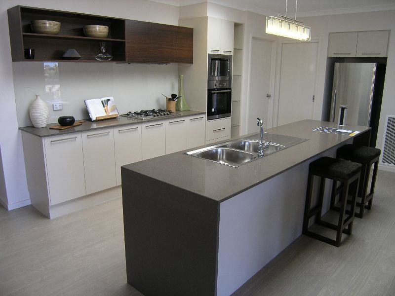 A kitchen with a large island and stools