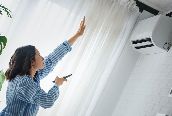 Woman Feeling The HVAC — Canberra, ACT — Heating & Cooling Services Canberra