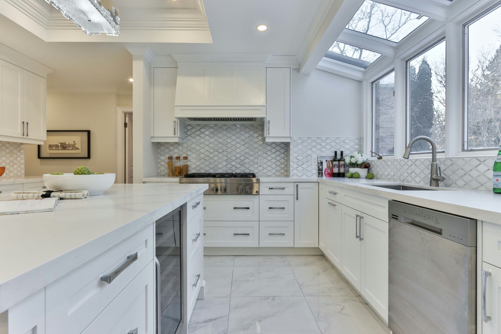 A kitchen with white cabinets and stainless steel appliances