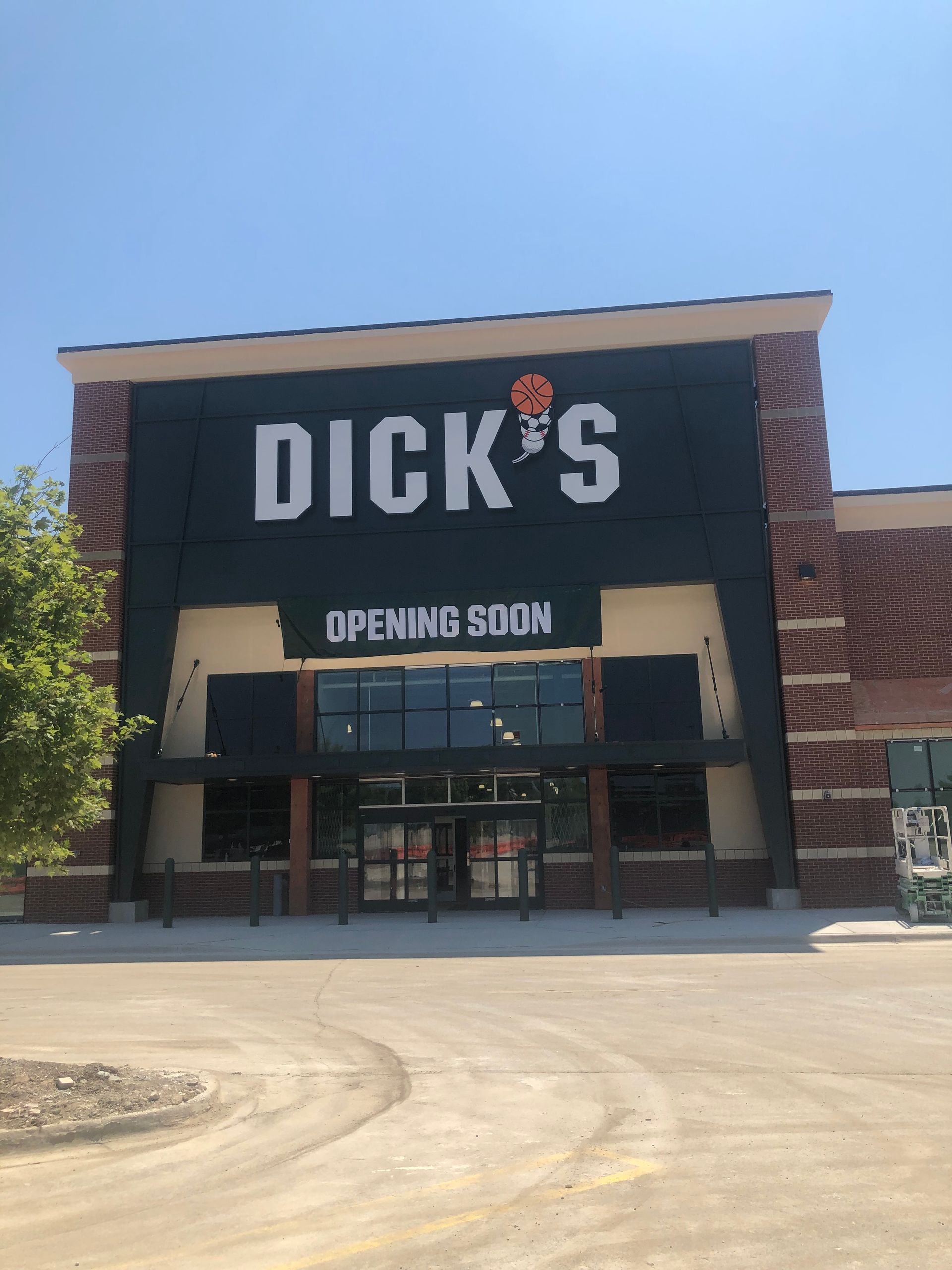 dicks storefront with an opening soon banner above the door