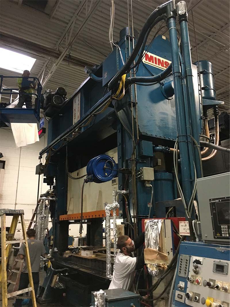 A man is working on a machine in a factory.