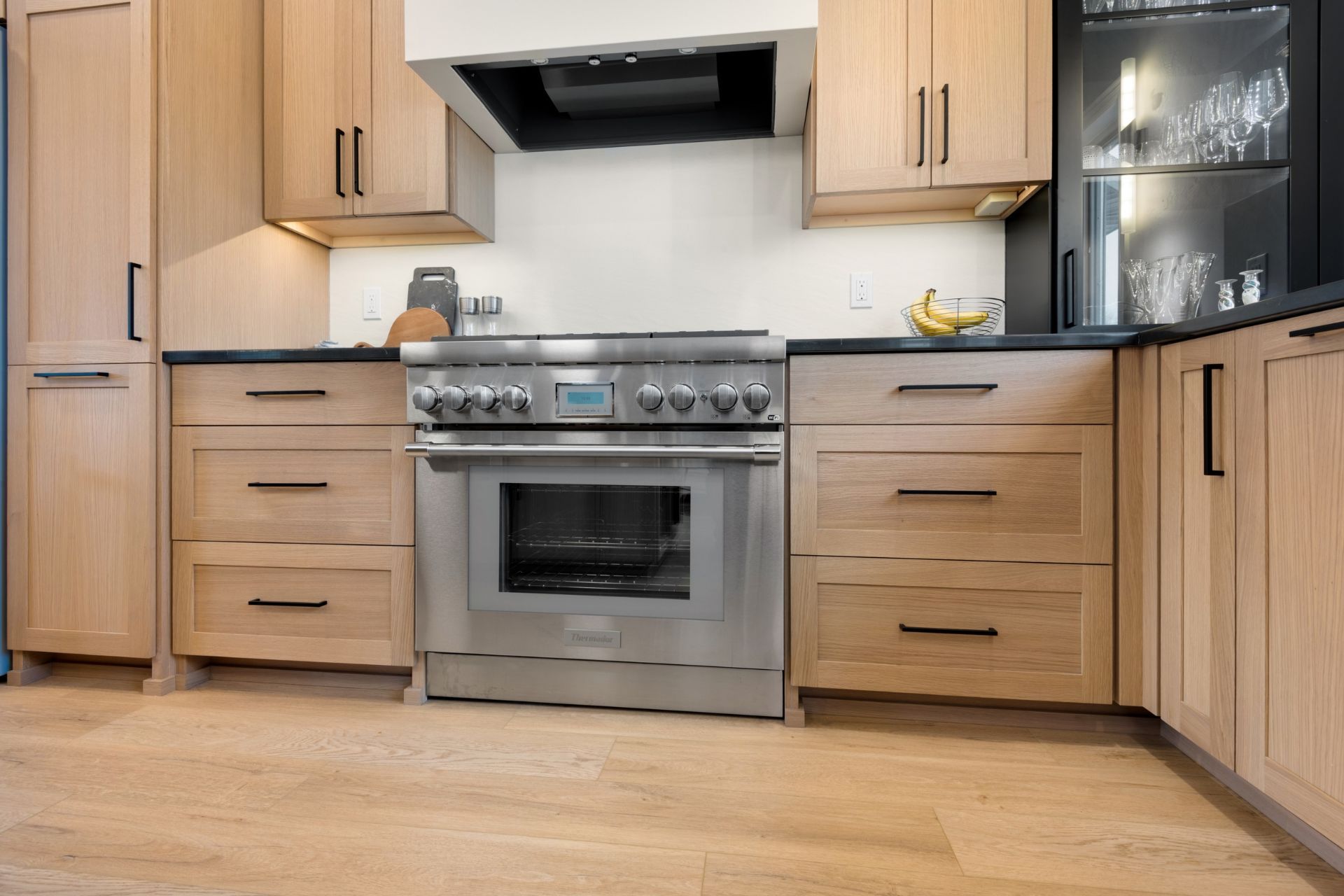 A kitchen with stainless steel appliances and wooden cabinets