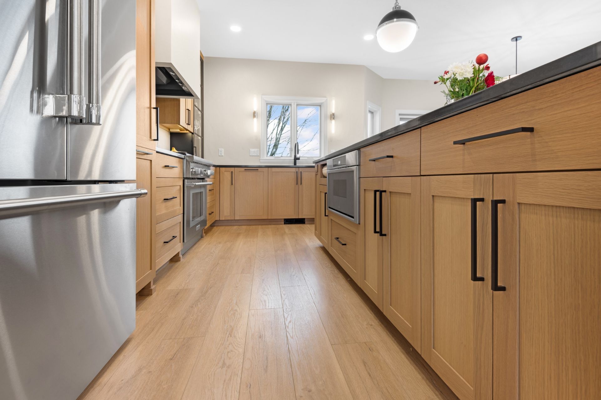 A kitchen with wooden cabinets and stainless steel appliances.