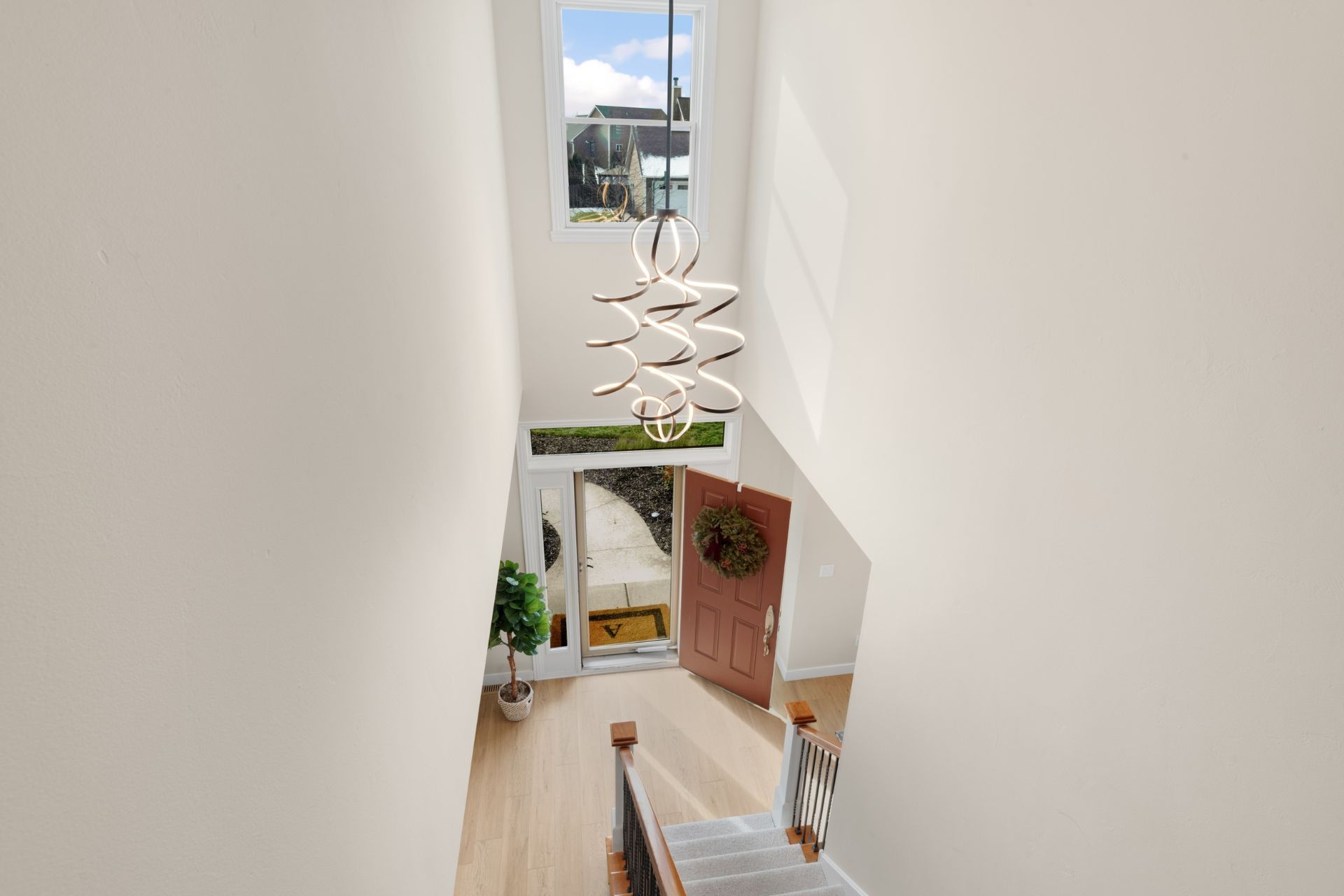 An aerial view of a staircase leading up to the second floor of a house.