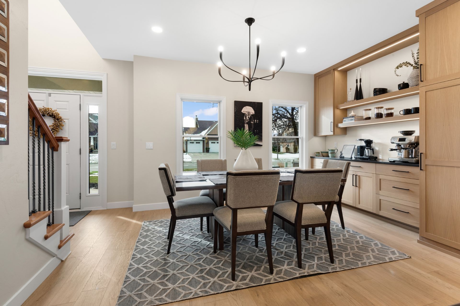 A dining room with a table and chairs and a rug