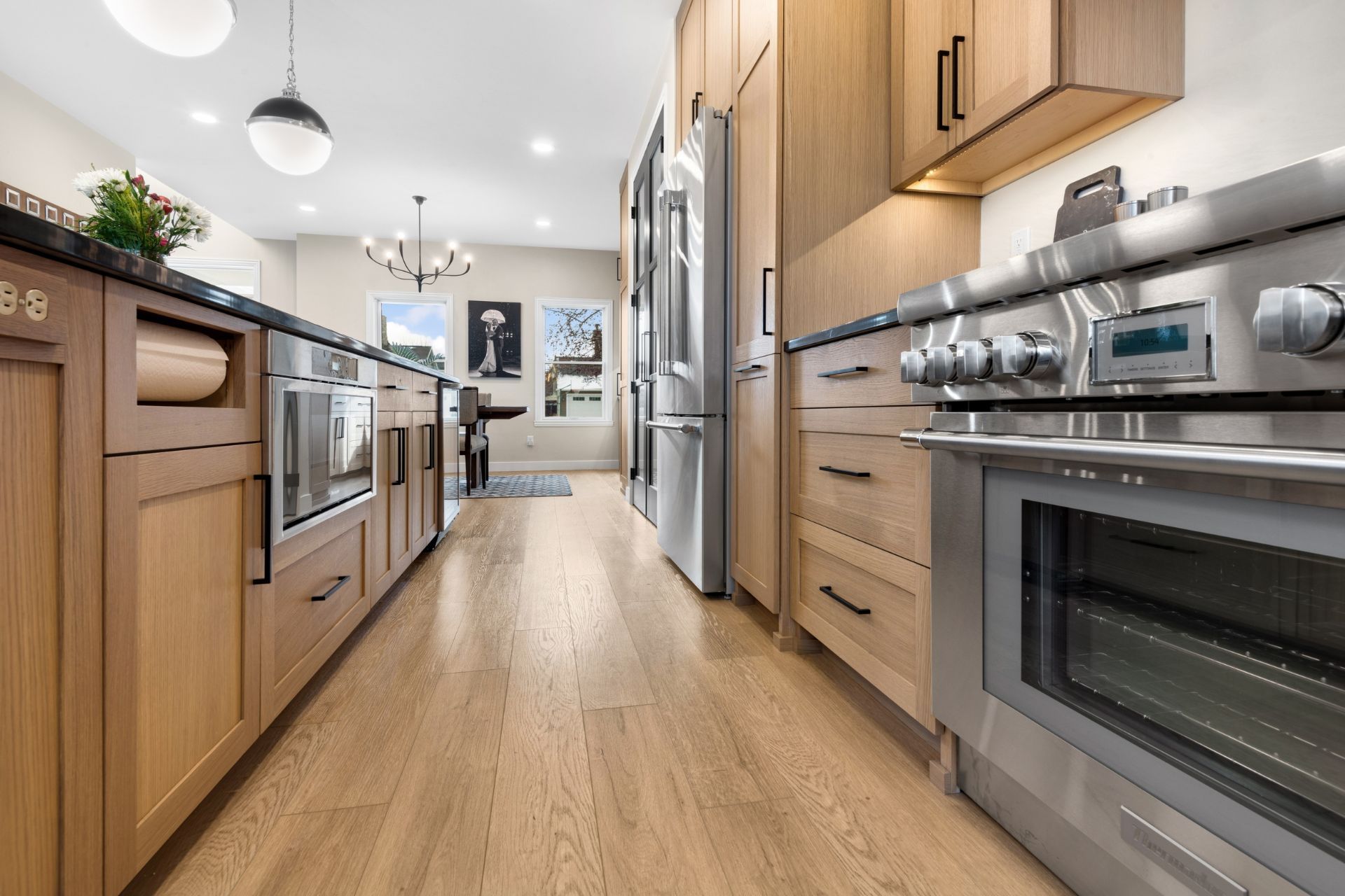 A kitchen with stainless steel appliances and wooden cabinets