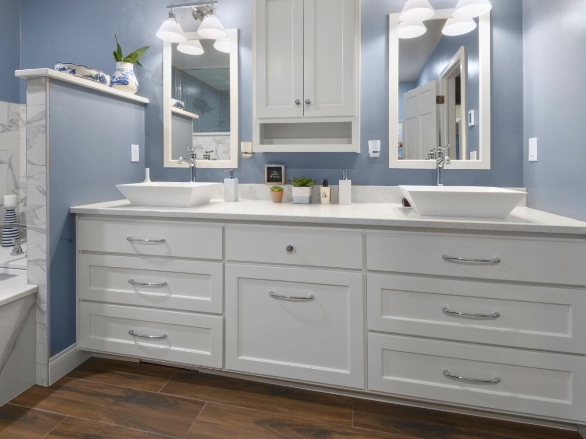 A bathroom with two sinks and two mirrors.