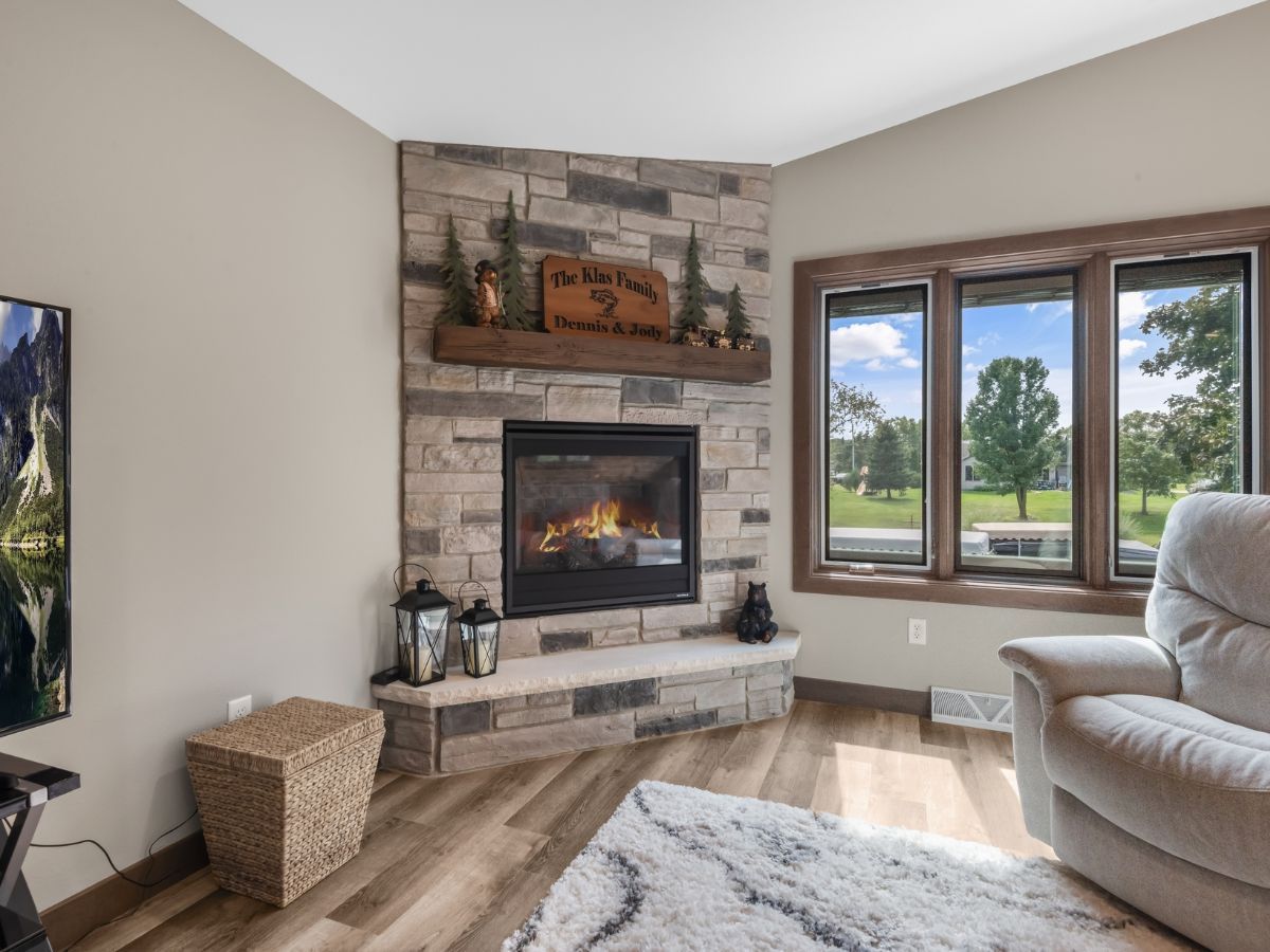 There is a fireplace in the corner of the living room.