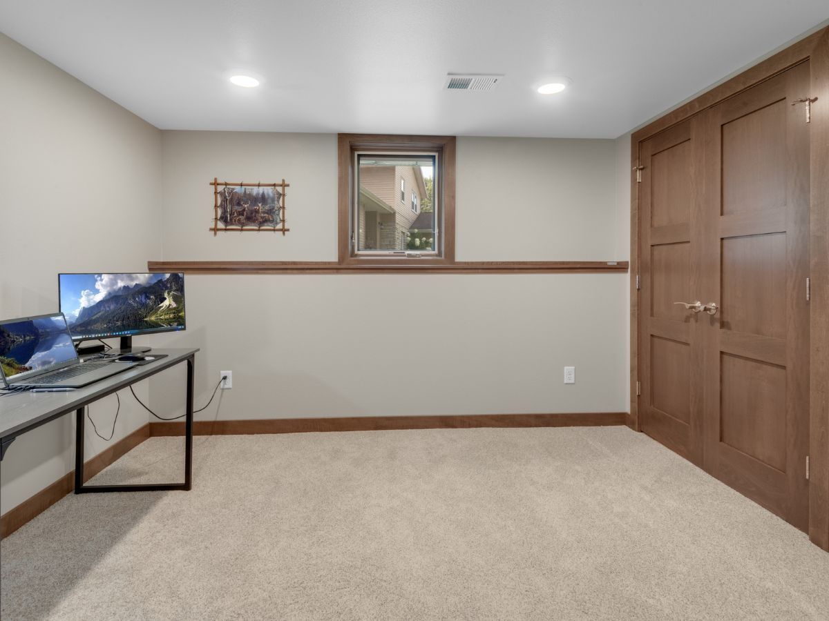 A room with a desk and a computer in it