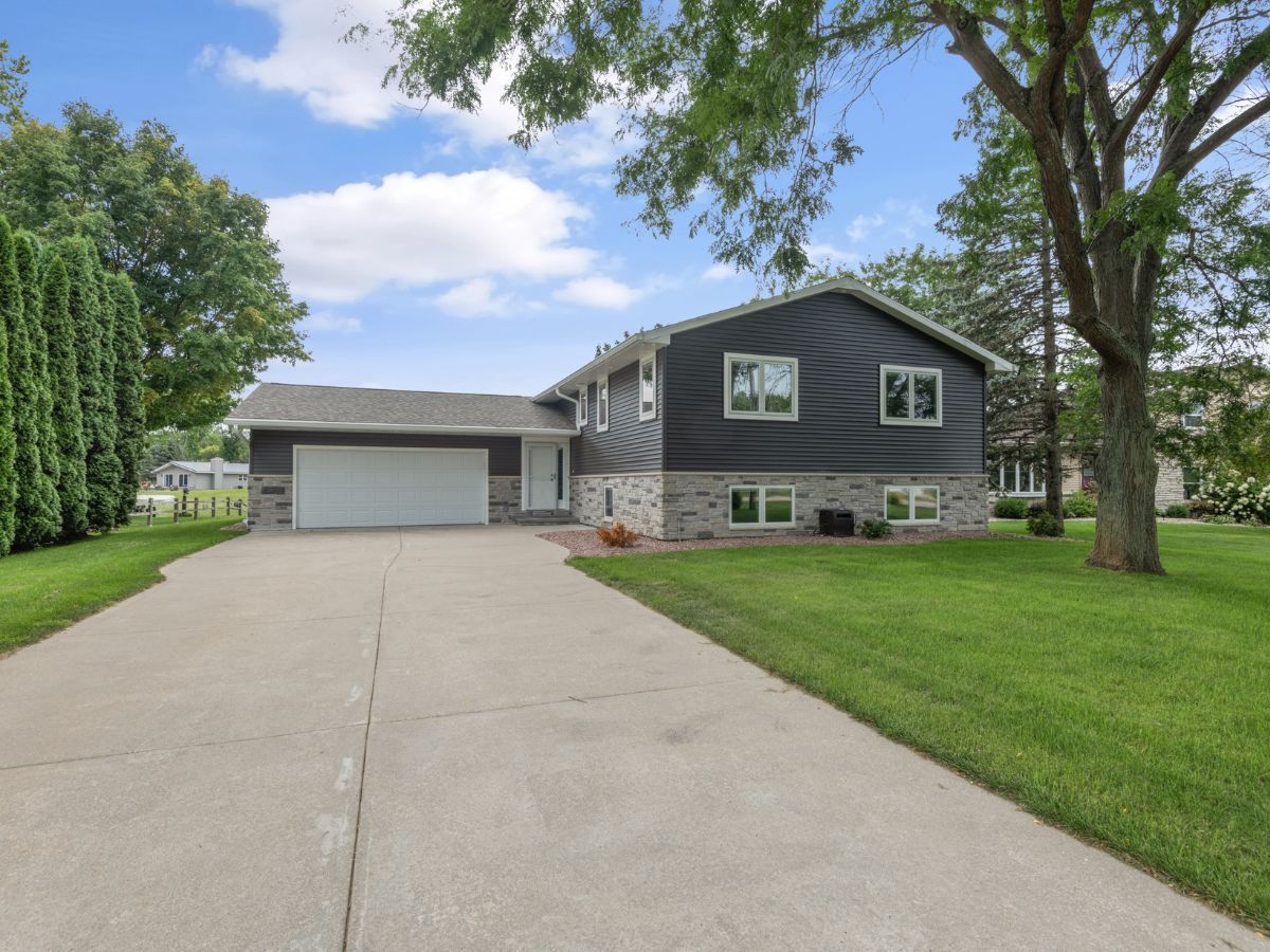 A house with a garage and a driveway in front of it