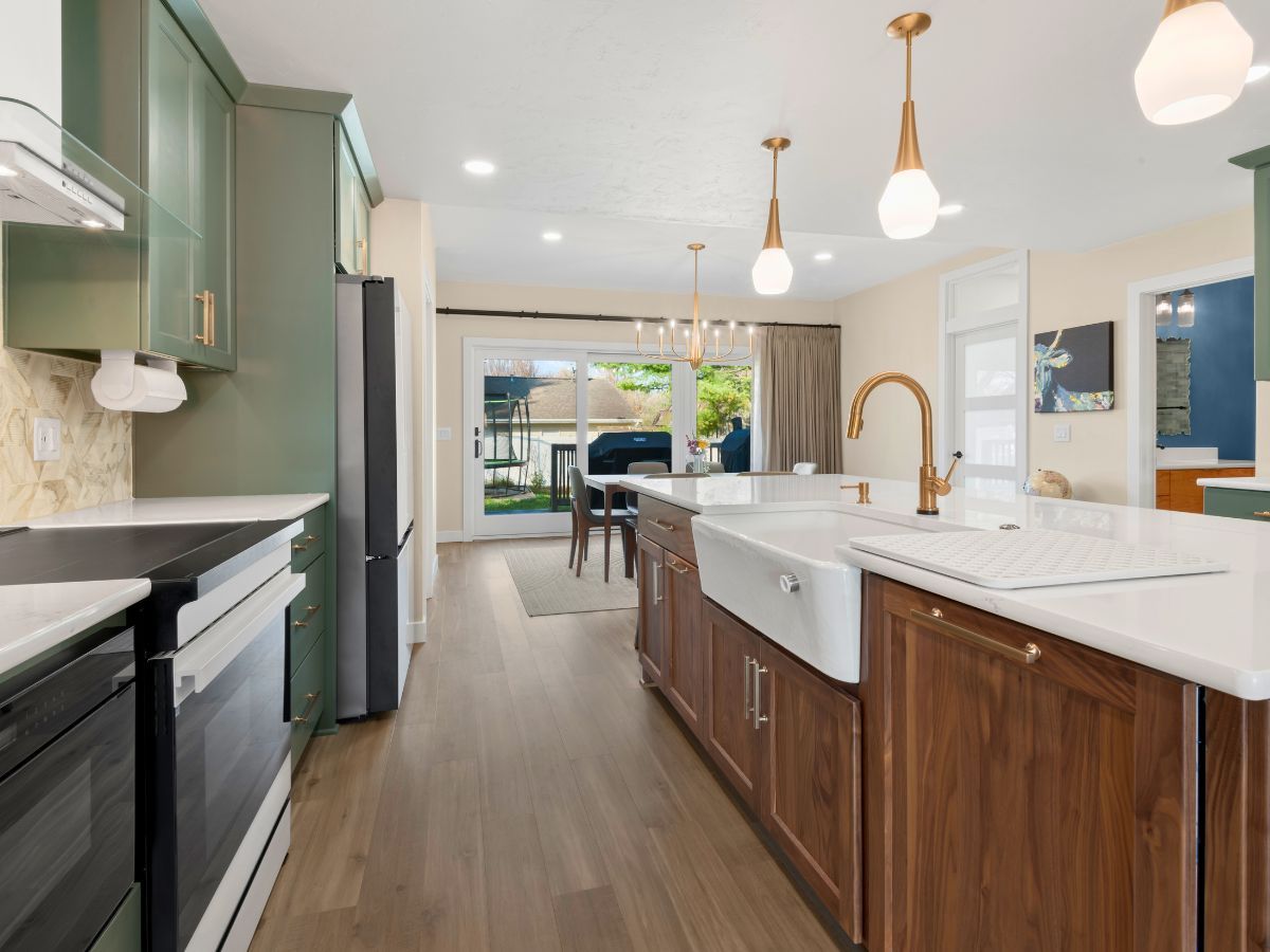 A kitchen with a sink , stove , refrigerator and dishwasher.