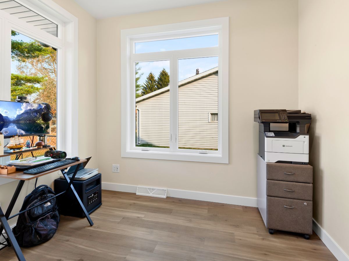 A room with a desk and a printer in it