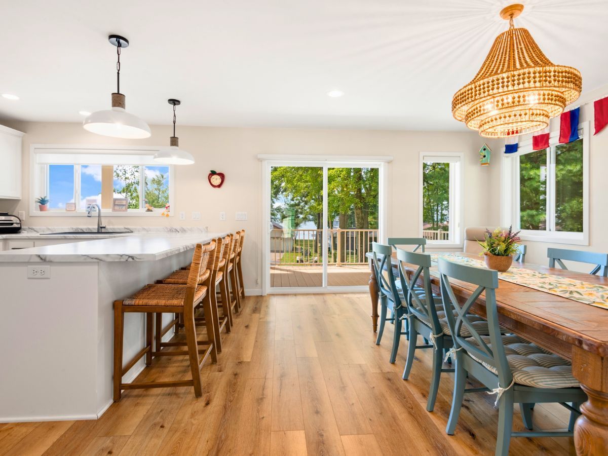 A kitchen and dining room in a house with a table and chairs.