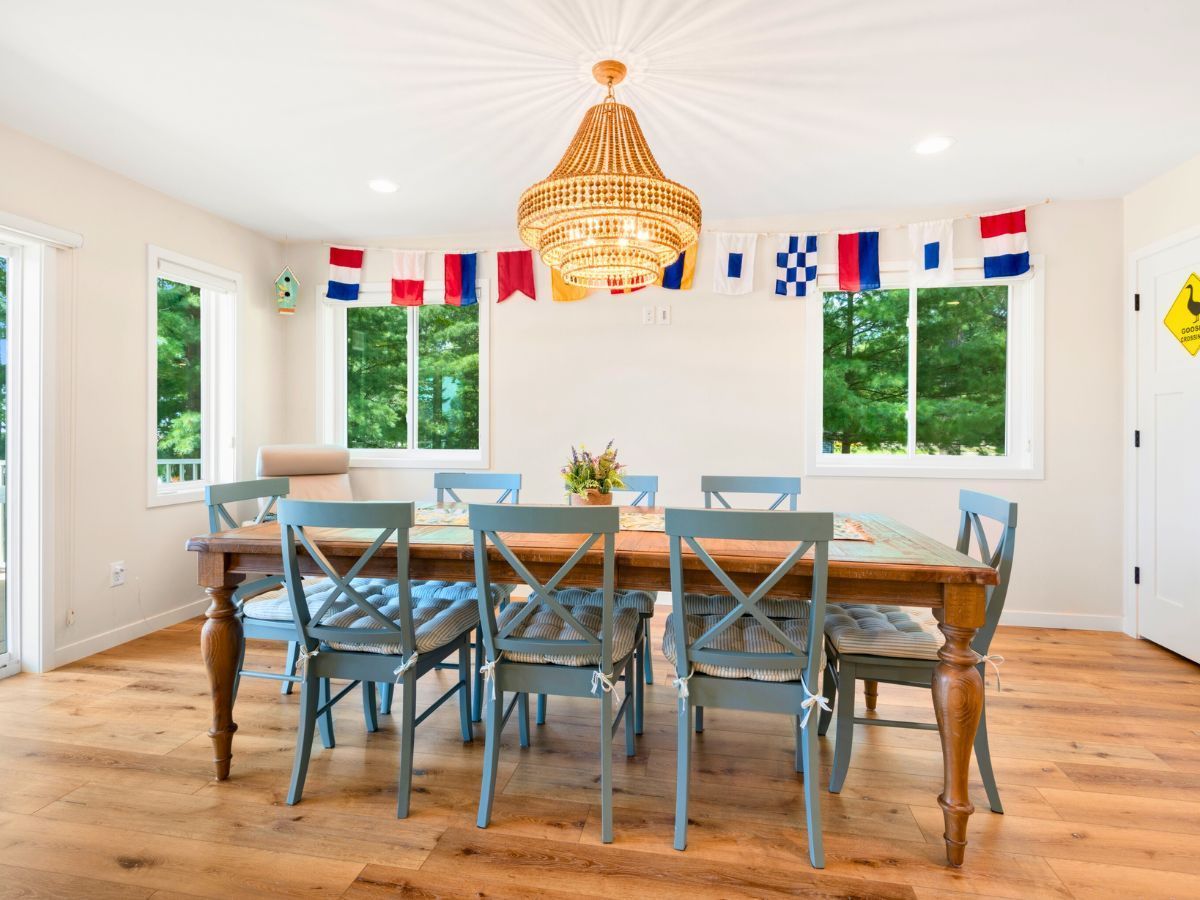 A dining room with a wooden table and blue chairs
