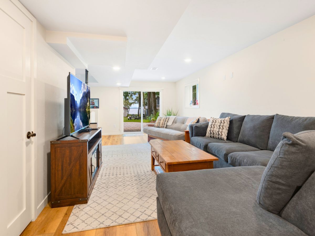 A living room with a couch , coffee table , and television.