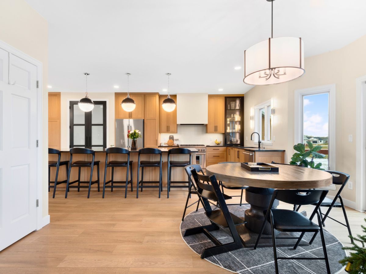A kitchen with a table and chairs in it