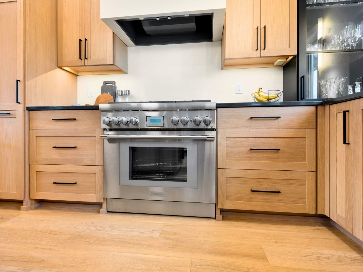 A kitchen with stainless steel appliances and wooden cabinets