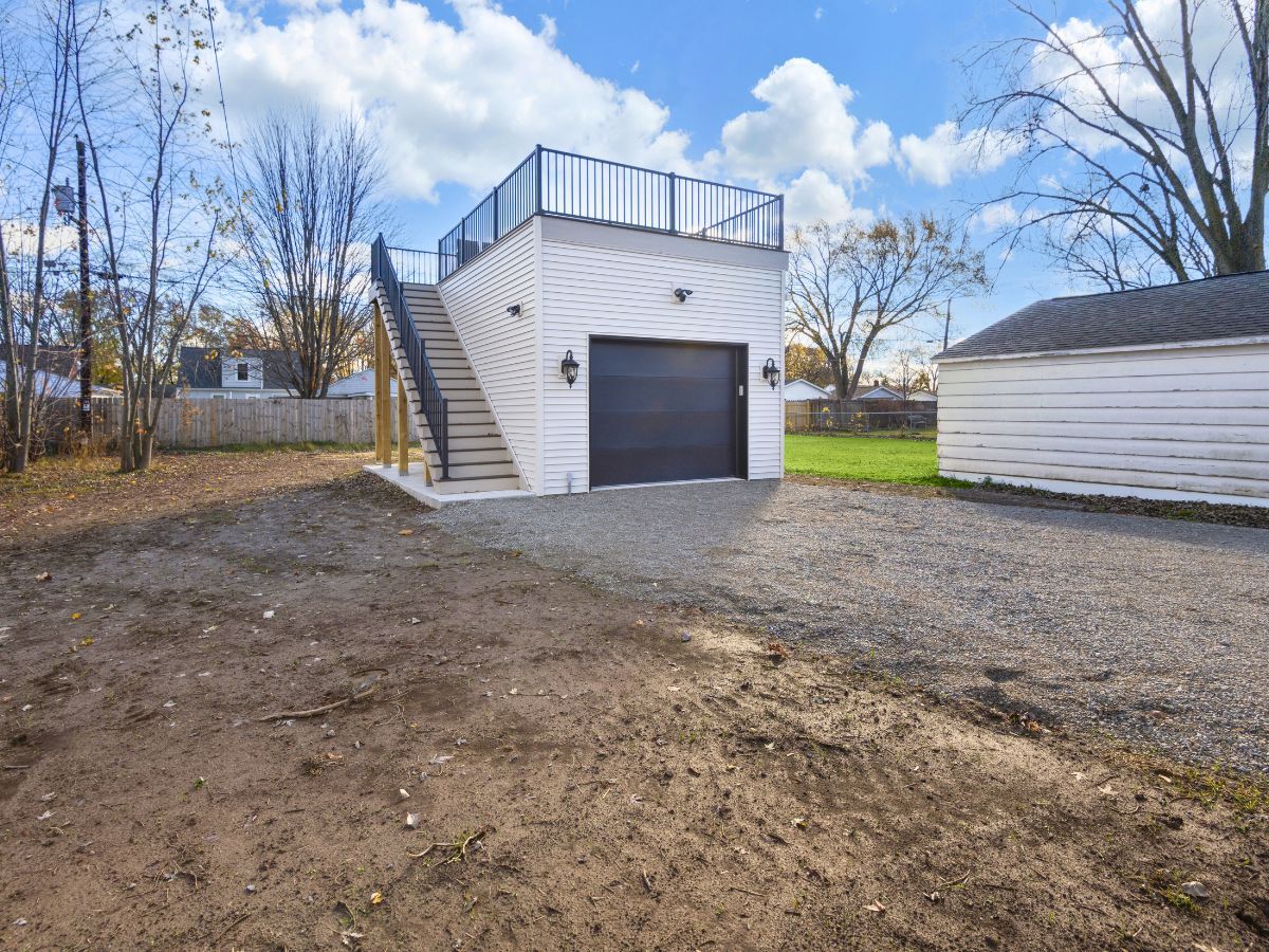 There is a garage with stairs leading up to it.