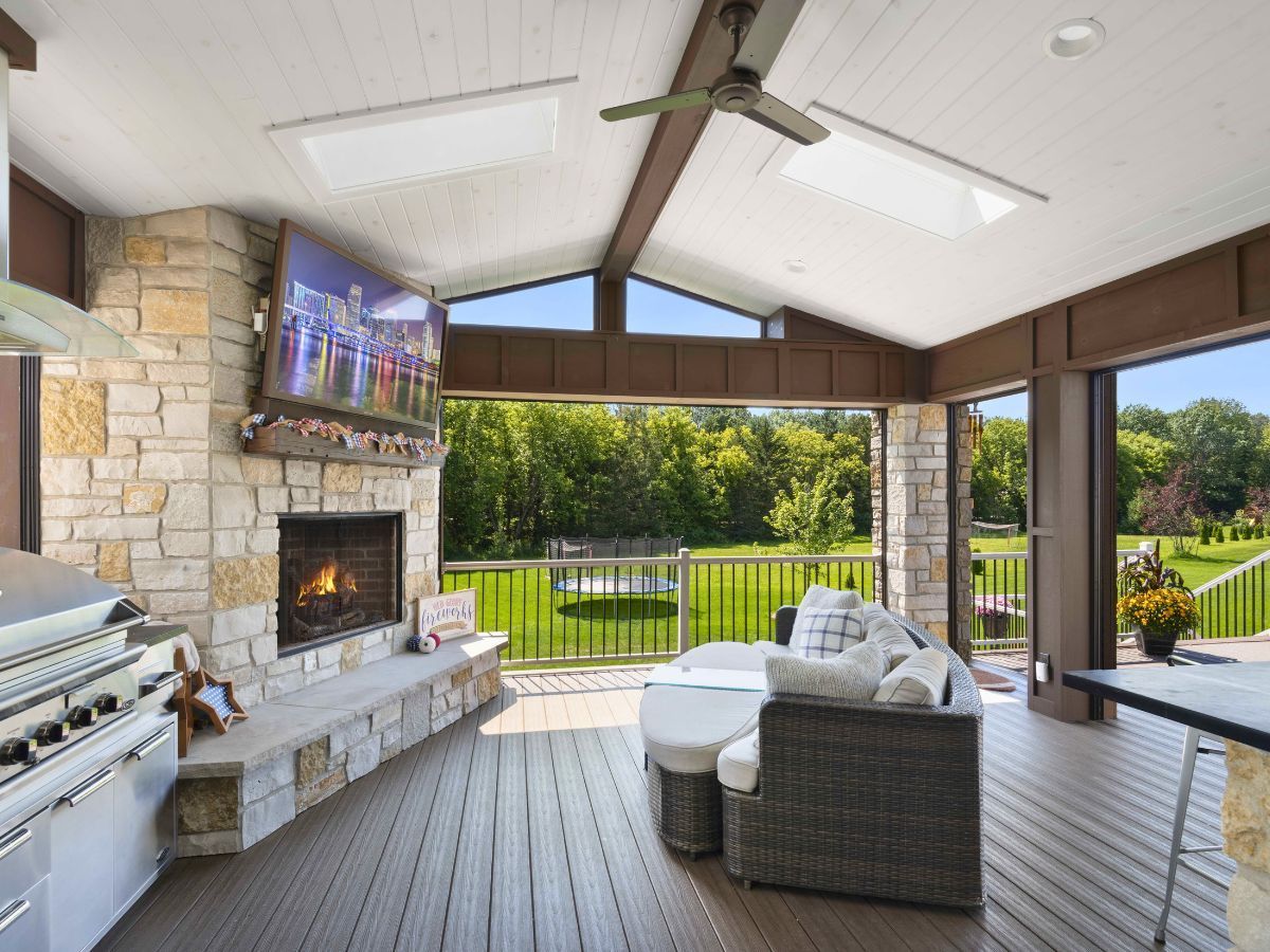 A living room with a fireplace and a television on the wall.