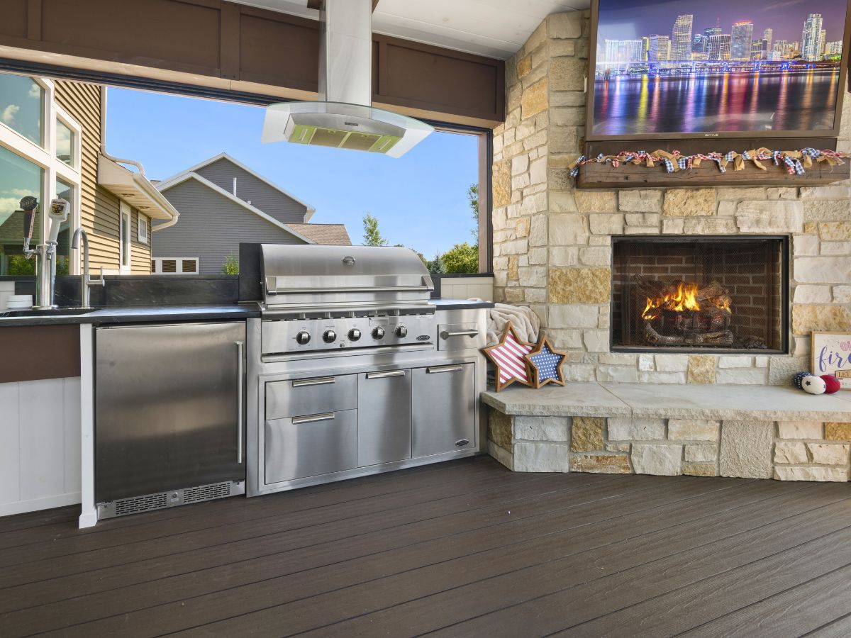A kitchen with a grill and a fireplace.