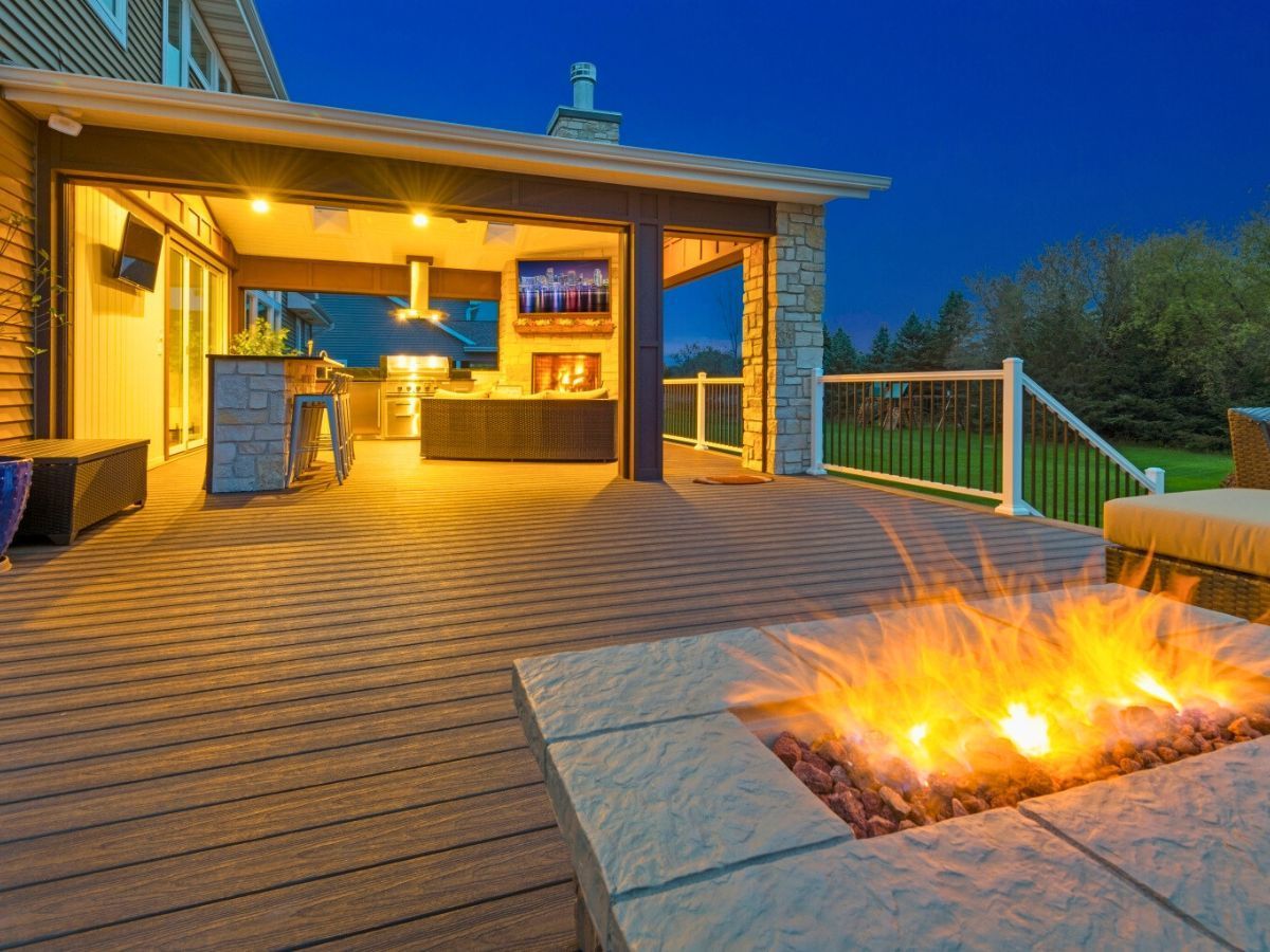 There is a fire pit on the deck of a house.