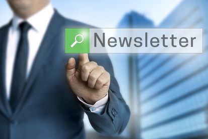 Businessman pressing “Newsletter” button on a digital interface