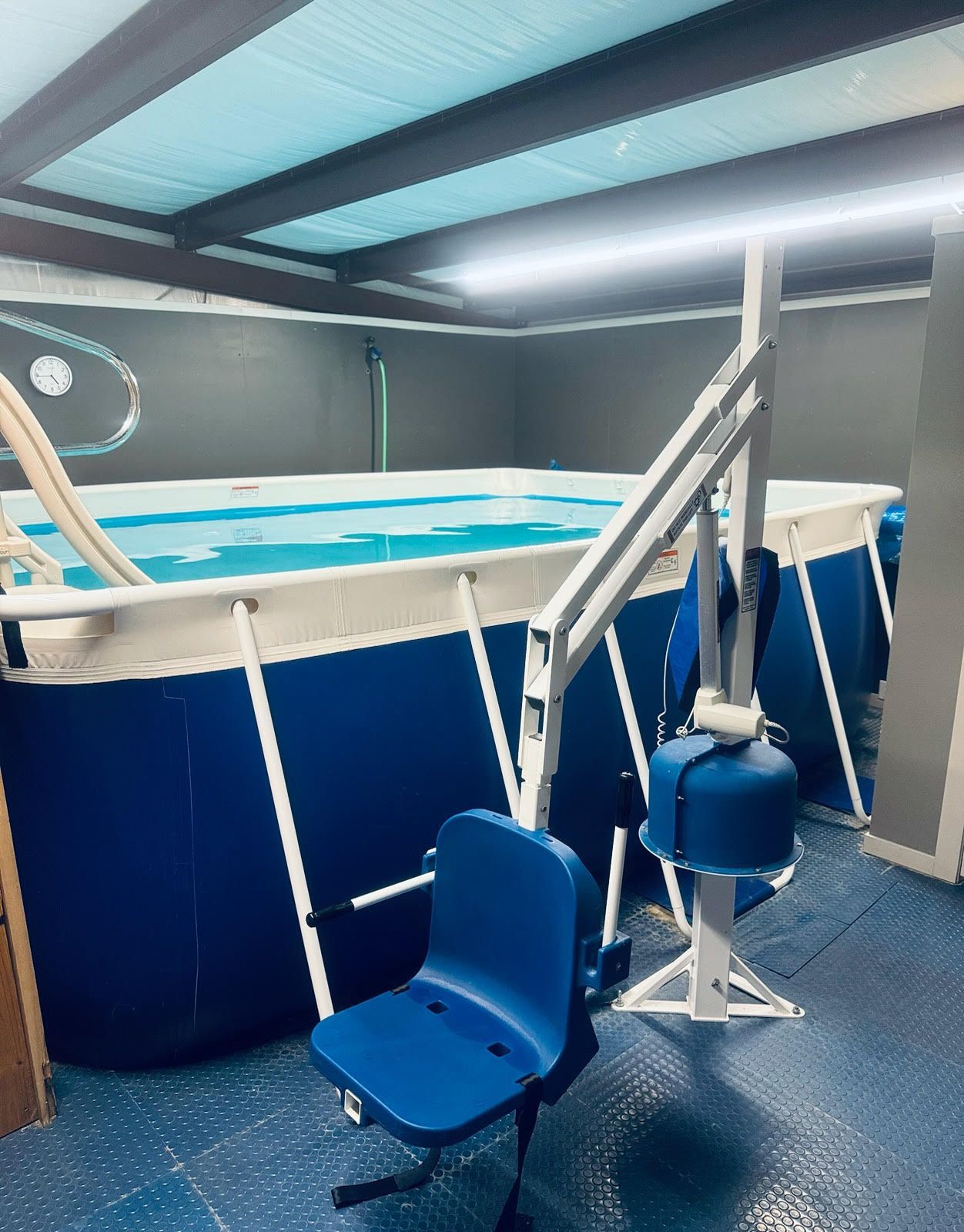 A swimming pool with a chair in front of it